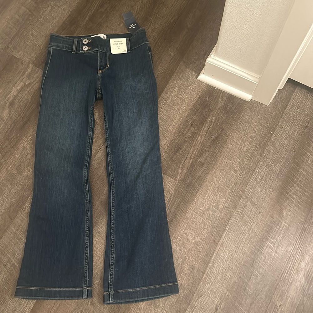 Wide leg, darker blue jeans and low rise